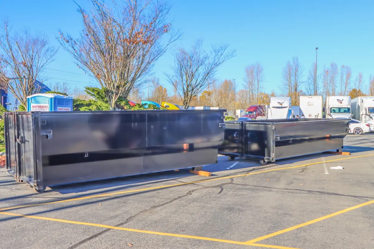 Professional dumpster rental service with roll-off container on residential driveway in Hickory Creek